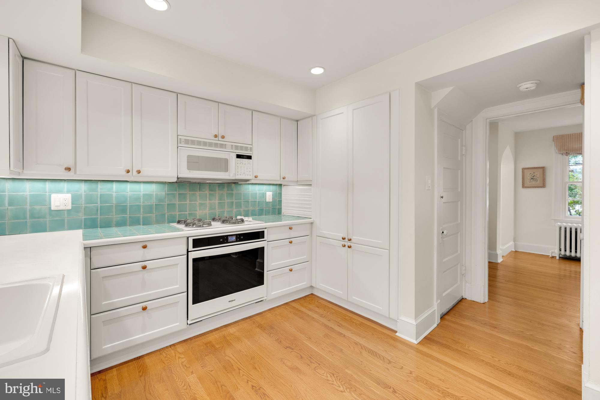 3514 Shepherd Street Chevy Chase, MD 20815 - Photo 10 of 42 a kitchen with stainless steel appliances white cabinets and a refrigerator