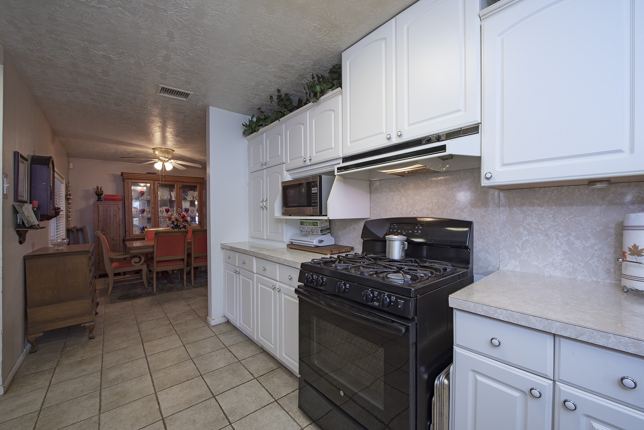 22234 Castle Road Waller, TX 77484 - Photo 23 of 50 a kitchen with granite countertop a stove sink and cabinets