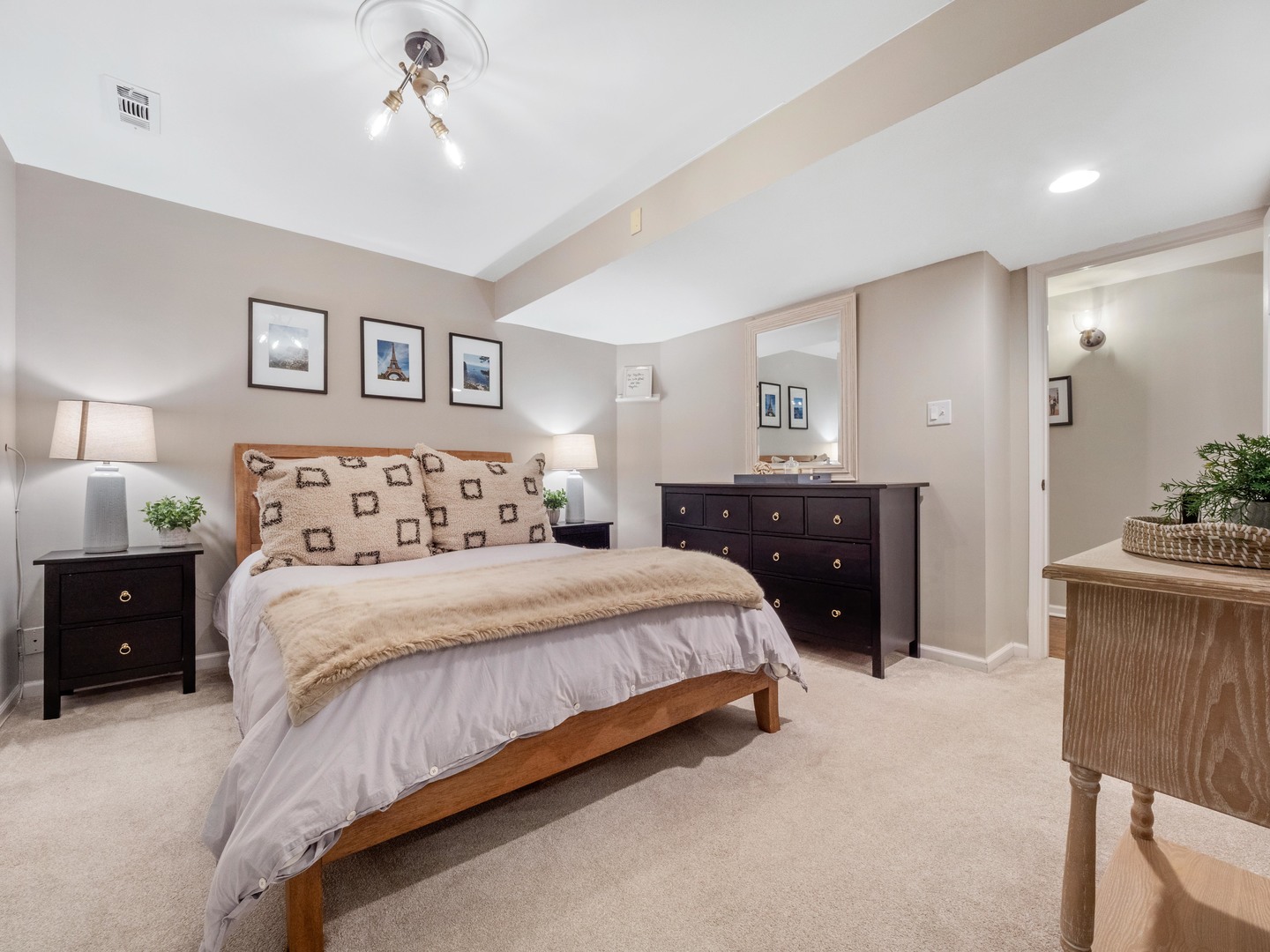 2439 North Burling Street, Unit G Chicago, IL 60614 - Photo 16 of 20 a spacious bedroom with a bed and a chandelier