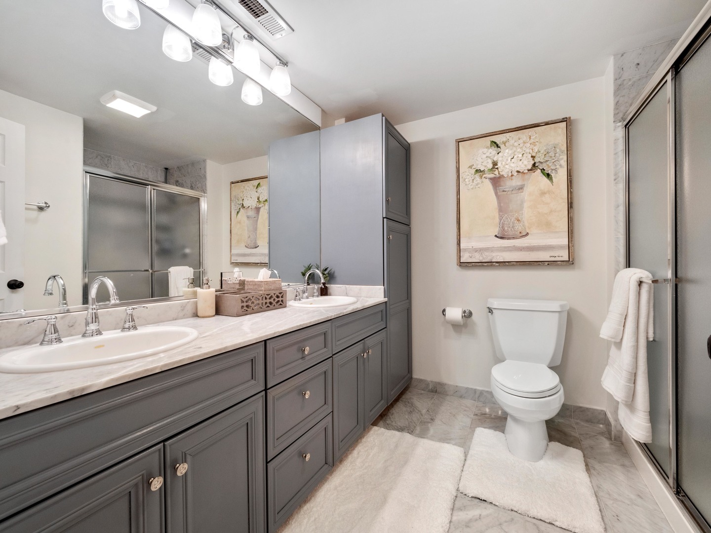2439 North Burling Street, Unit G Chicago, IL 60614 - Photo 17 of 20 a bathroom with a double vanity sink and a toilet