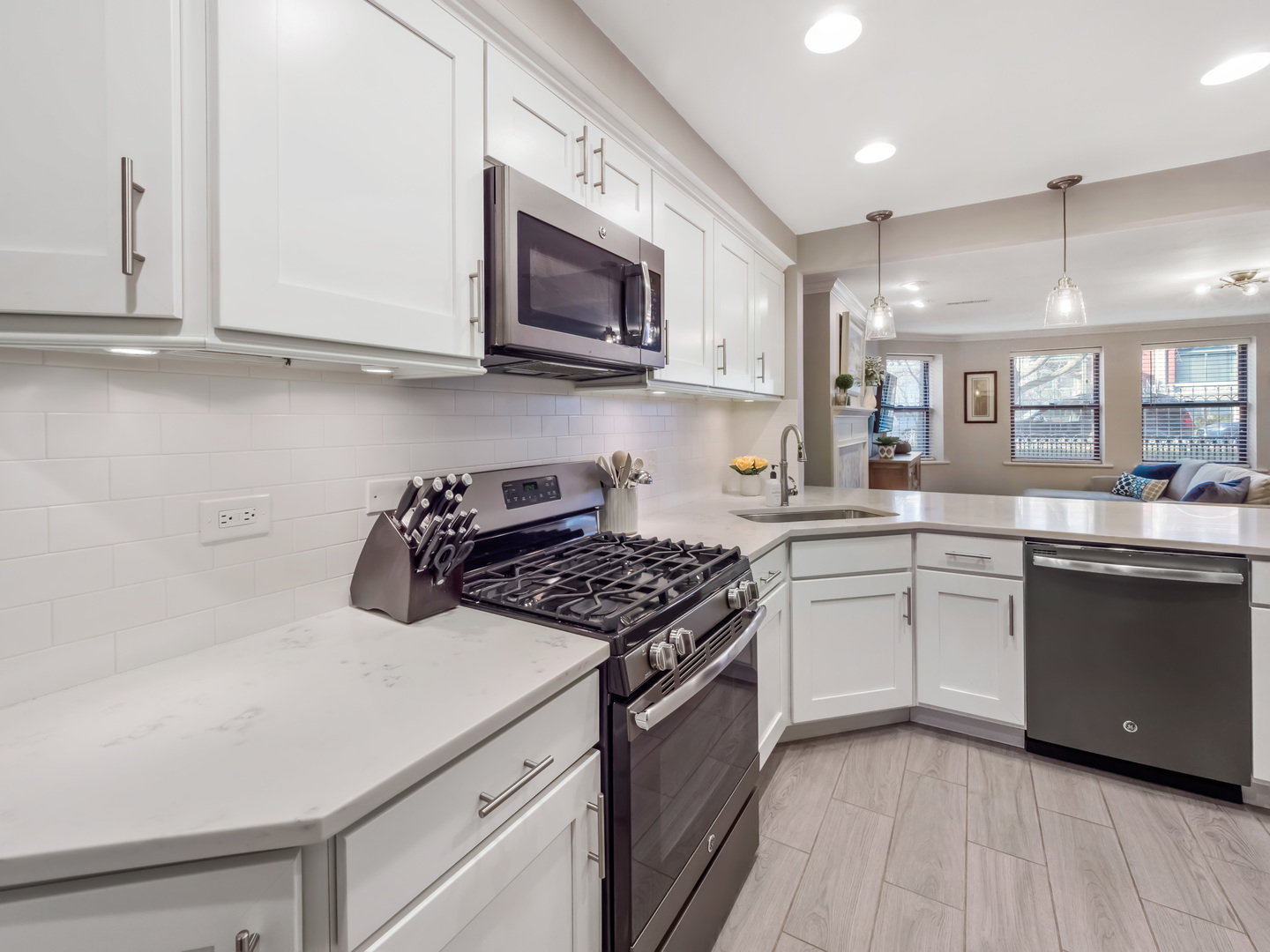 2439 North Burling Street, Unit G Chicago, IL 60614 - Photo 6 of 20 a kitchen with stainless steel appliances a sink dishwasher a stove top oven a counter space and cabinets