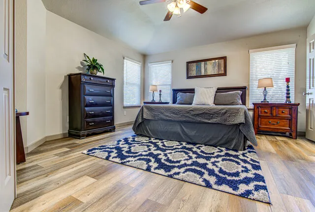 a bedroom with a bed and a chandelier