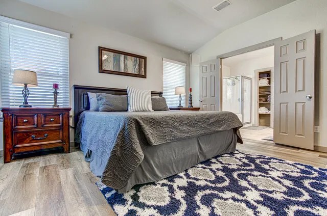 a bedroom with a bed and a dresser