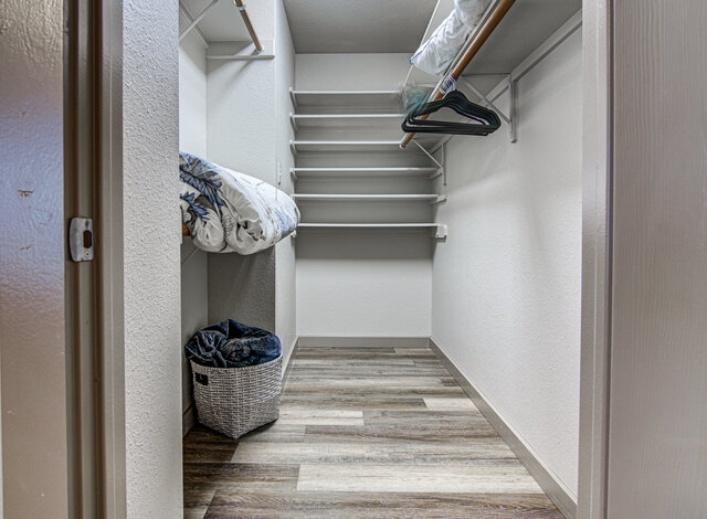 7712 Earp Way Austin, TX 78729 - Photo 19 of 37 a view of walk in closet with clothes and shoes