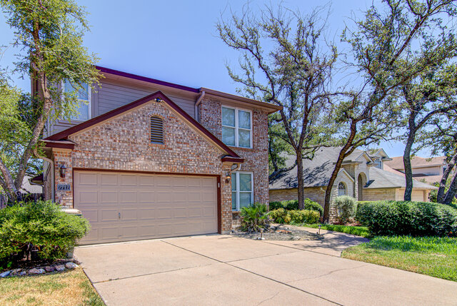 7712 Earp Way Austin, TX 78729 - Photo 2 of 37 a front view of a house with a garden