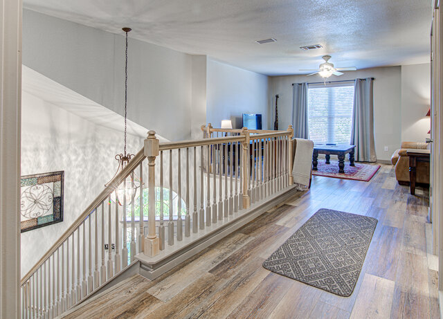 7712 Earp Way Austin, TX 78729 - Photo 22 of 37 a view of staircase with wooden floor and a window