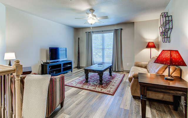 7712 Earp Way Austin, TX 78729 - Photo 25 of 37 a living room with furniture a fireplace and a window