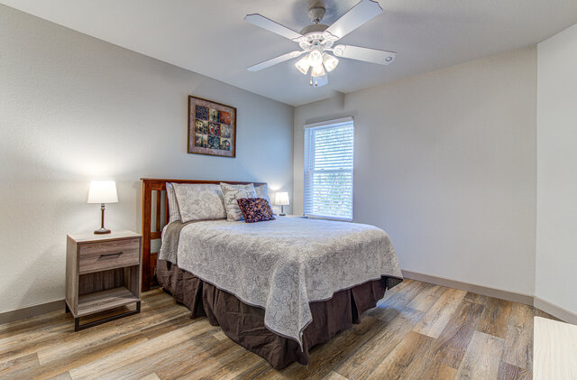 7712 Earp Way Austin, TX 78729 - Photo 30 of 37 a bedroom with a bed and a chandelier