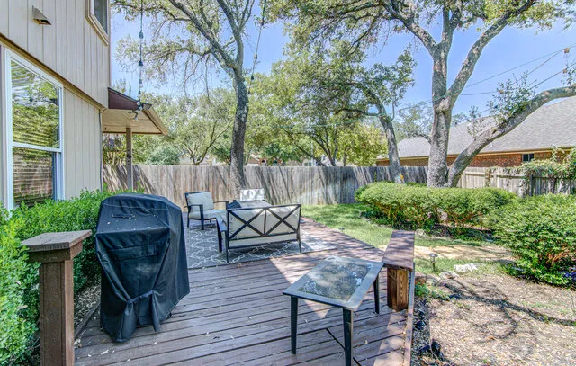 a view of a chairs and table in the patio along the house