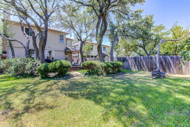 7712 Earp Way Austin, TX 78729 - Photo 37 of 37 a view of a backyard with plants and large tree
