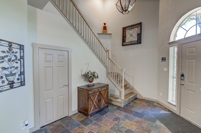 7712 Earp Way Austin, TX 78729 - Photo 4 of 37 a view of entryway with hallway and stairs