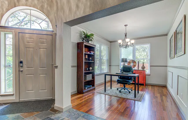 a view of a livingroom with furniture window and wooden floor
