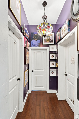154 West 400 North Springville, UT 84663 - Photo 18 of 43 Wood-finish flooring with a multi-door hallway and a colorful stained-glass chandelier