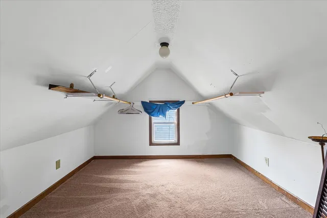 a view of a room with stairs and white walls