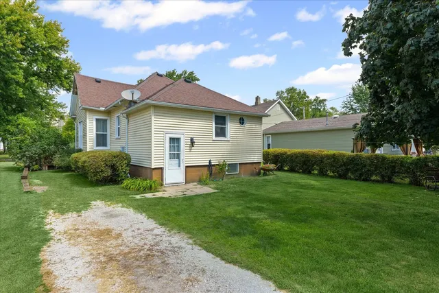 a front view of a house with a garden