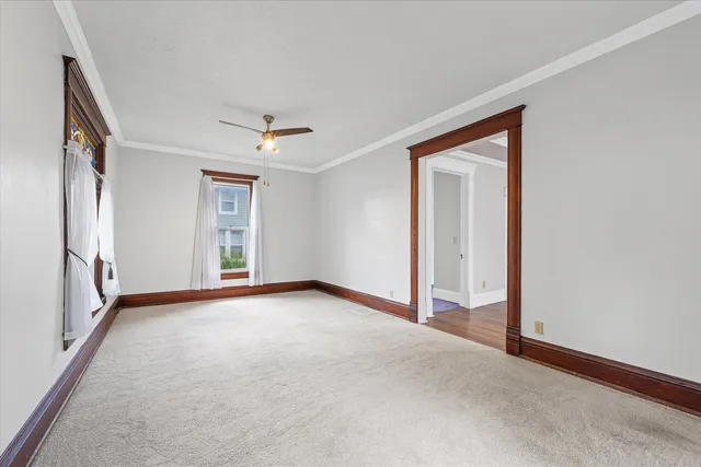 a view of a livingroom with a ceiling fan and window