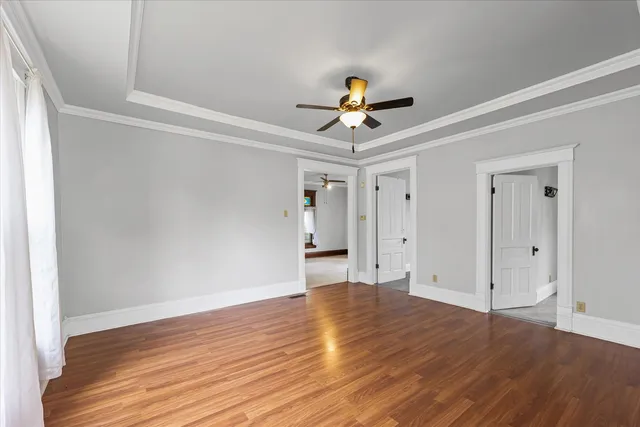 a view of room with wooden floor and ceiling fan