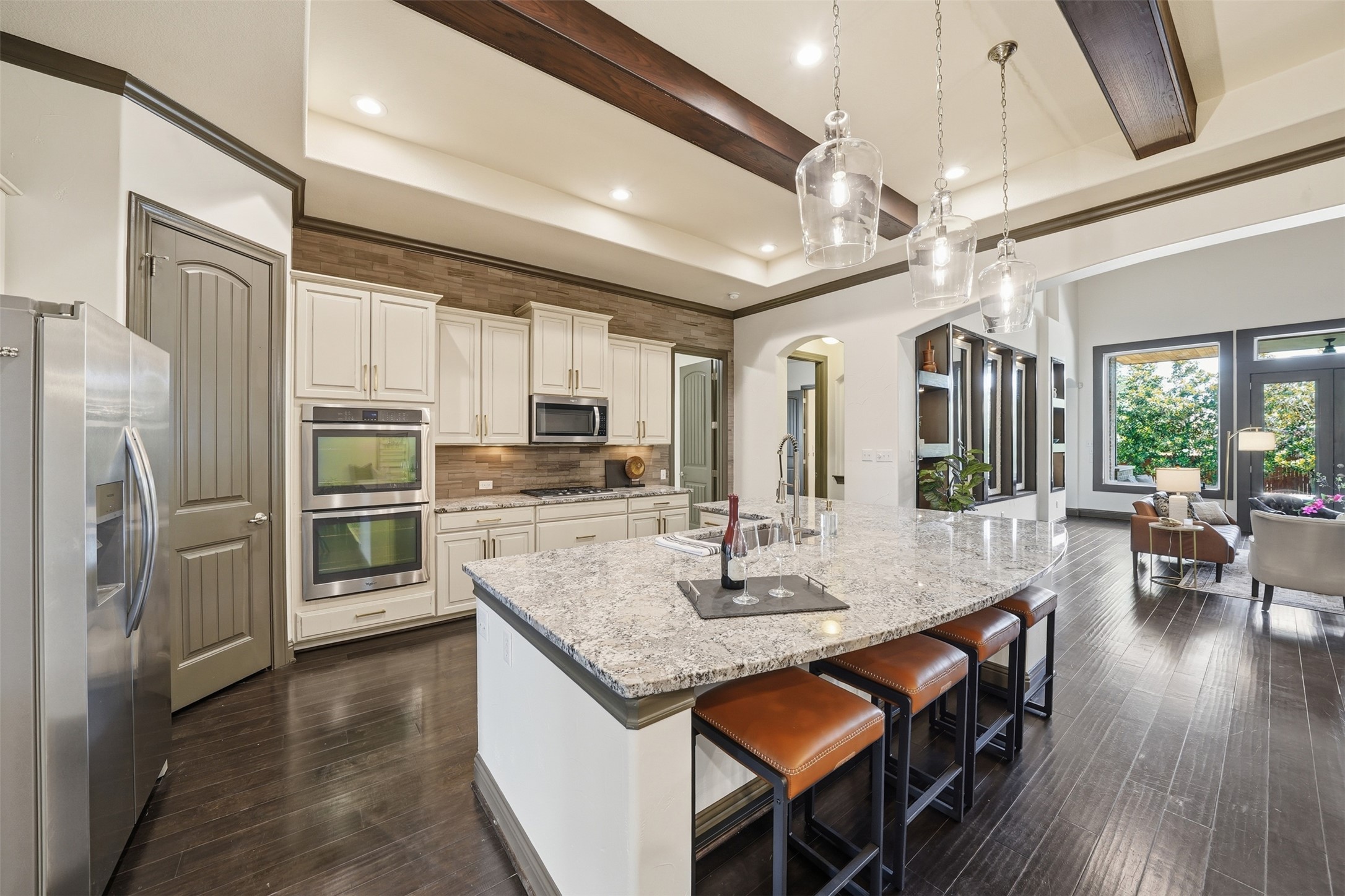 8729 Vantage Point Drive Austin, TX 78737 - Photo 16 of 33 Rich hardwood floors complement a spacious kitchen island, ideal for casual dining.