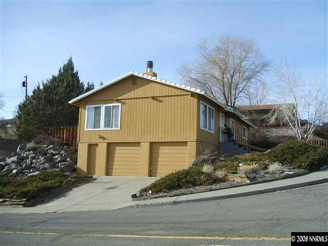 400 Talus Way Reno, NV 89503 - Photo 7 of 8 a front view of a house with a yard and garage