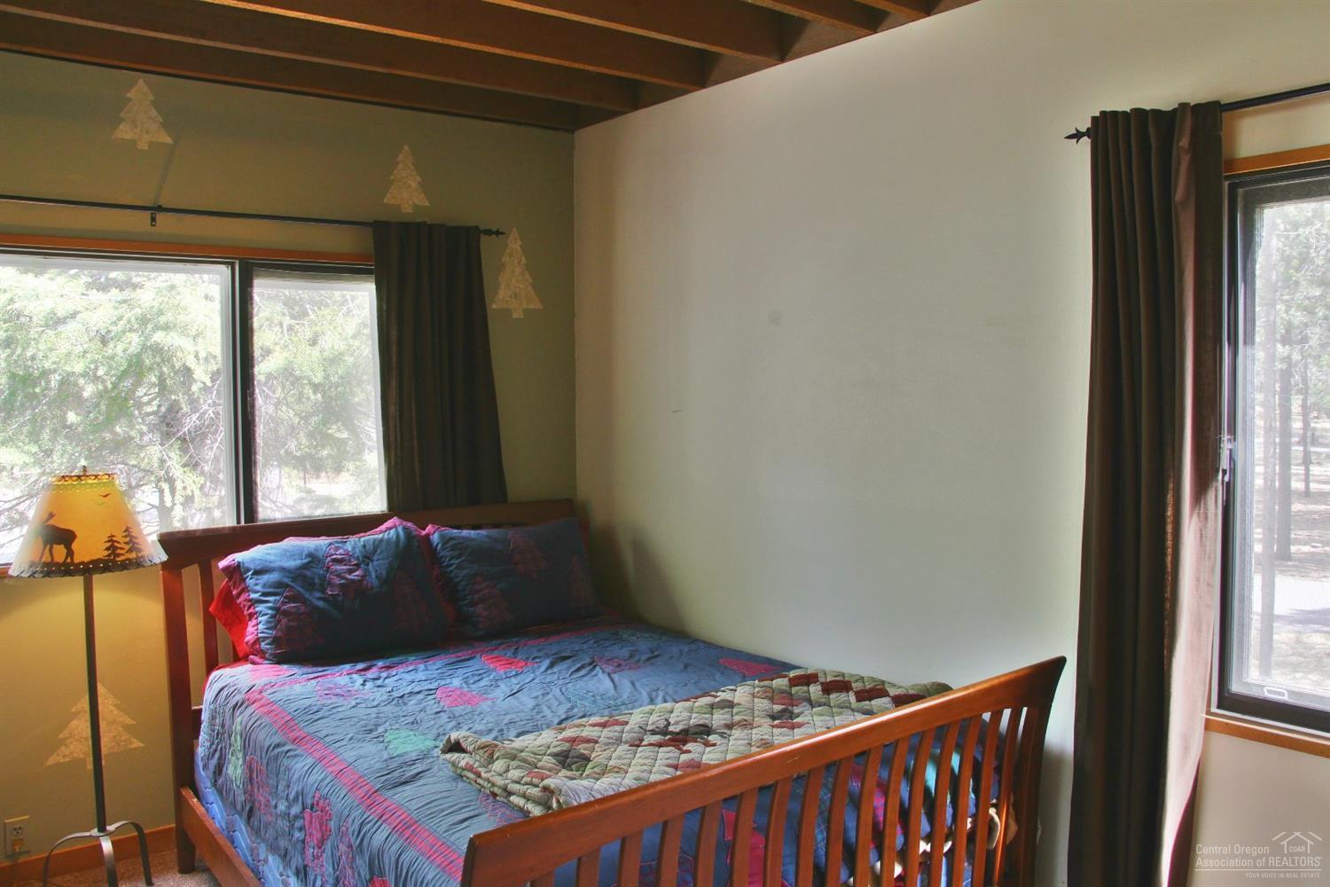 4 Meadow House Loop Sunriver, OR 97707 - Photo 12 of 17 a bedroom with a bed and a window