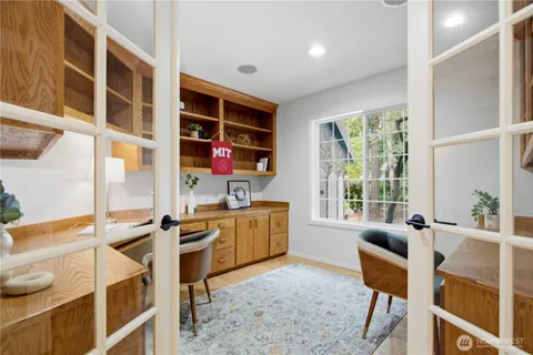 a dining room with furniture and a window