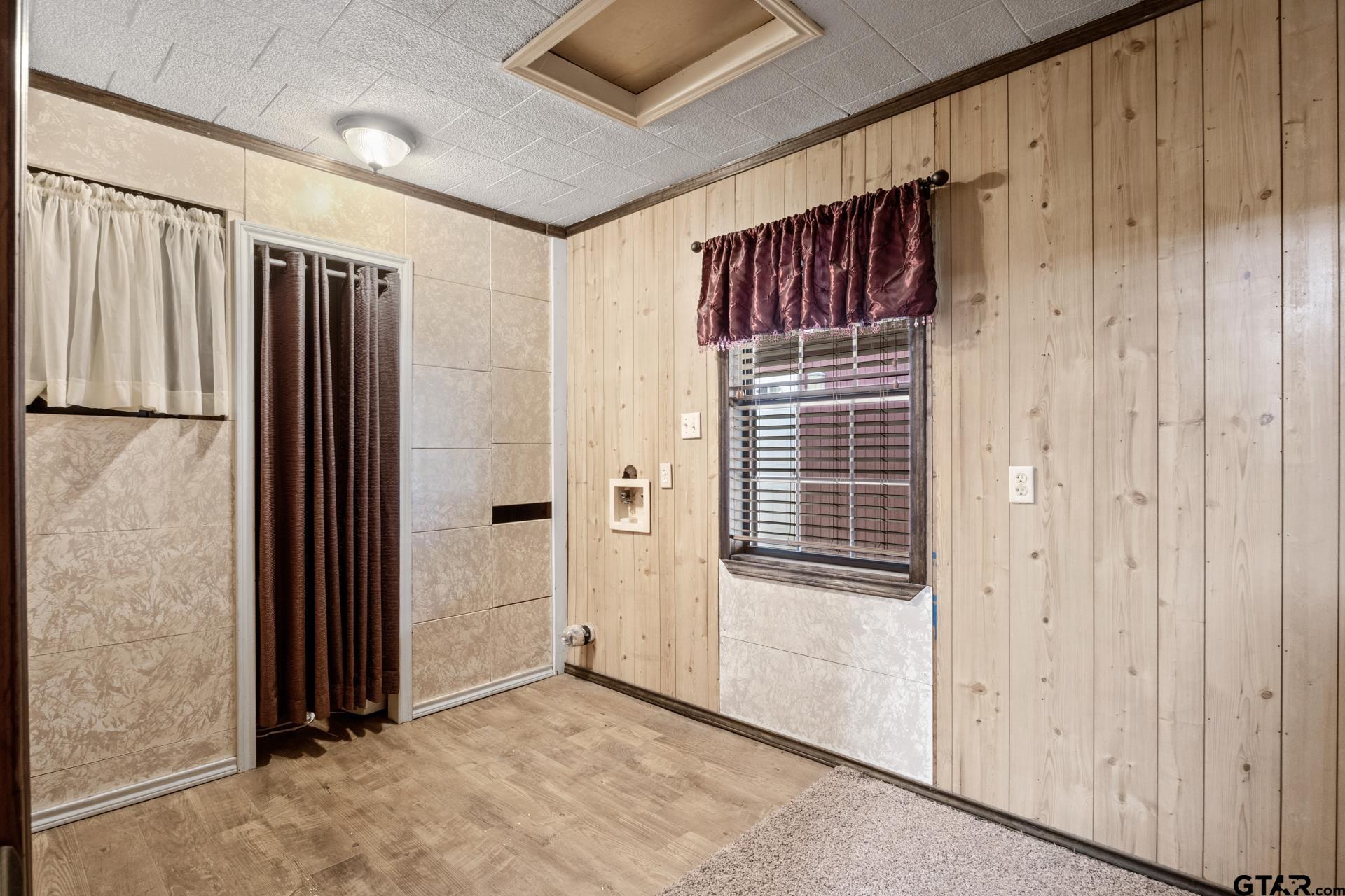 71 Private Road Pittsburg, TX 75686 - Photo 11 of 39 a view of a hallway with wooden walls