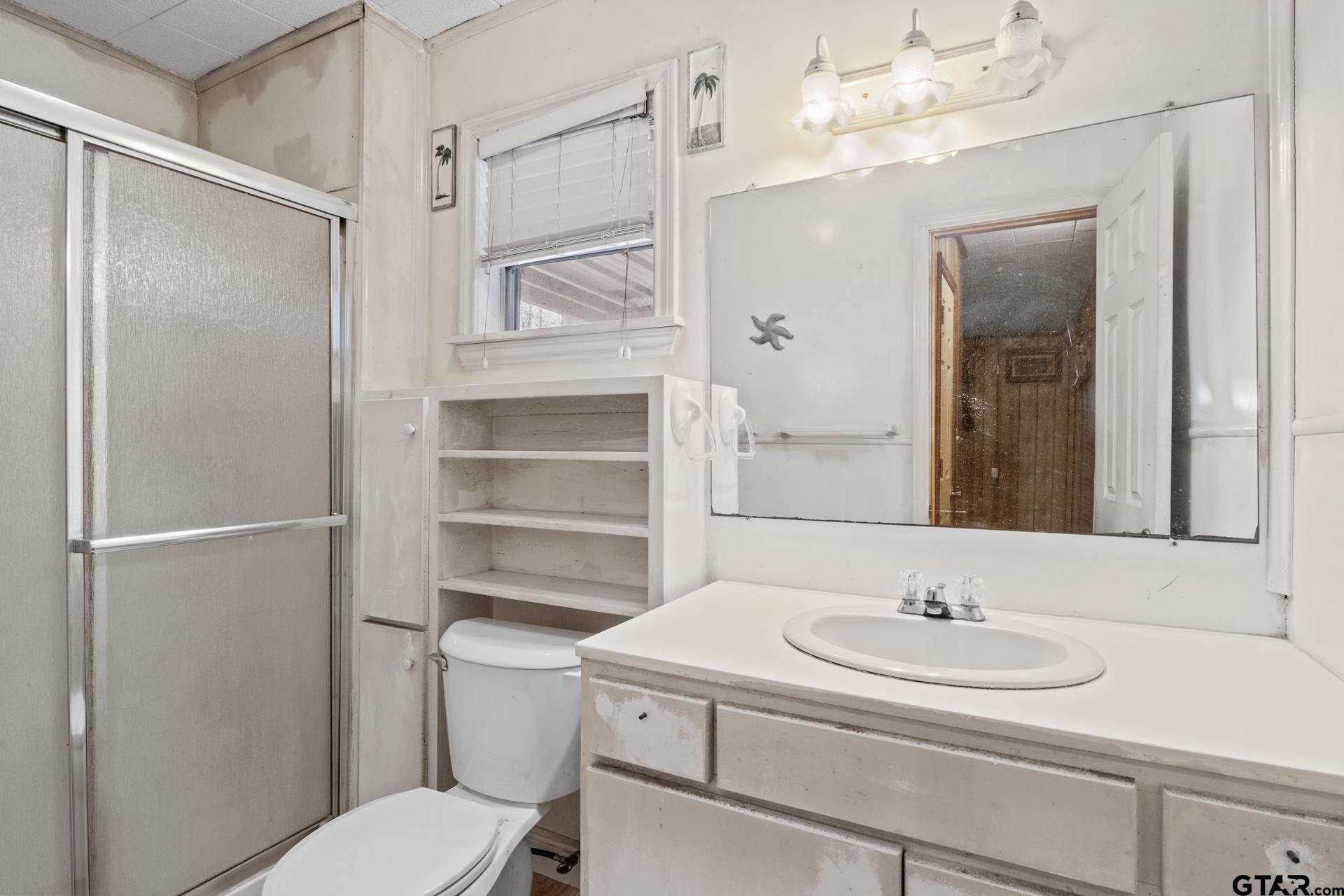71 Private Road Pittsburg, TX 75686 - Photo 15 of 39 a bathroom with a sink toilet vanity and shower