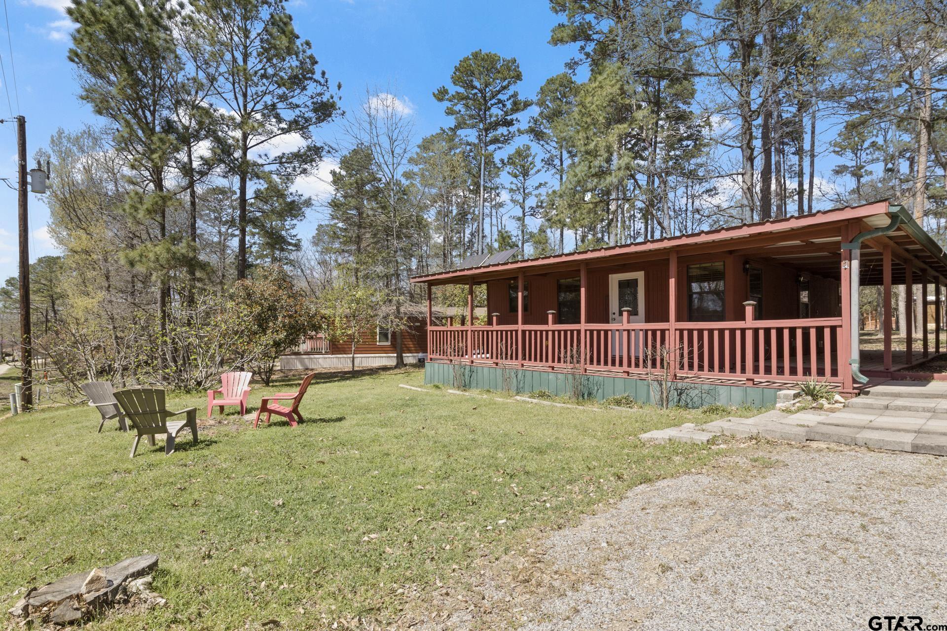 71 Private Road Pittsburg, TX 75686 - Photo 20 of 39 a backyard of a house with table and chairs