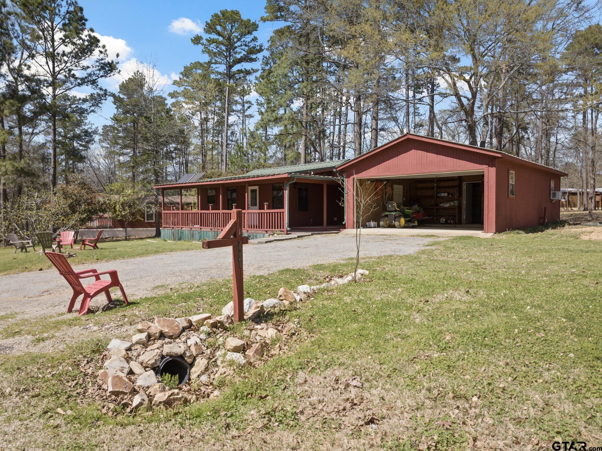 71 Private Road Pittsburg, TX 75686 - Photo 2 of 39 a front view of a house with a yard