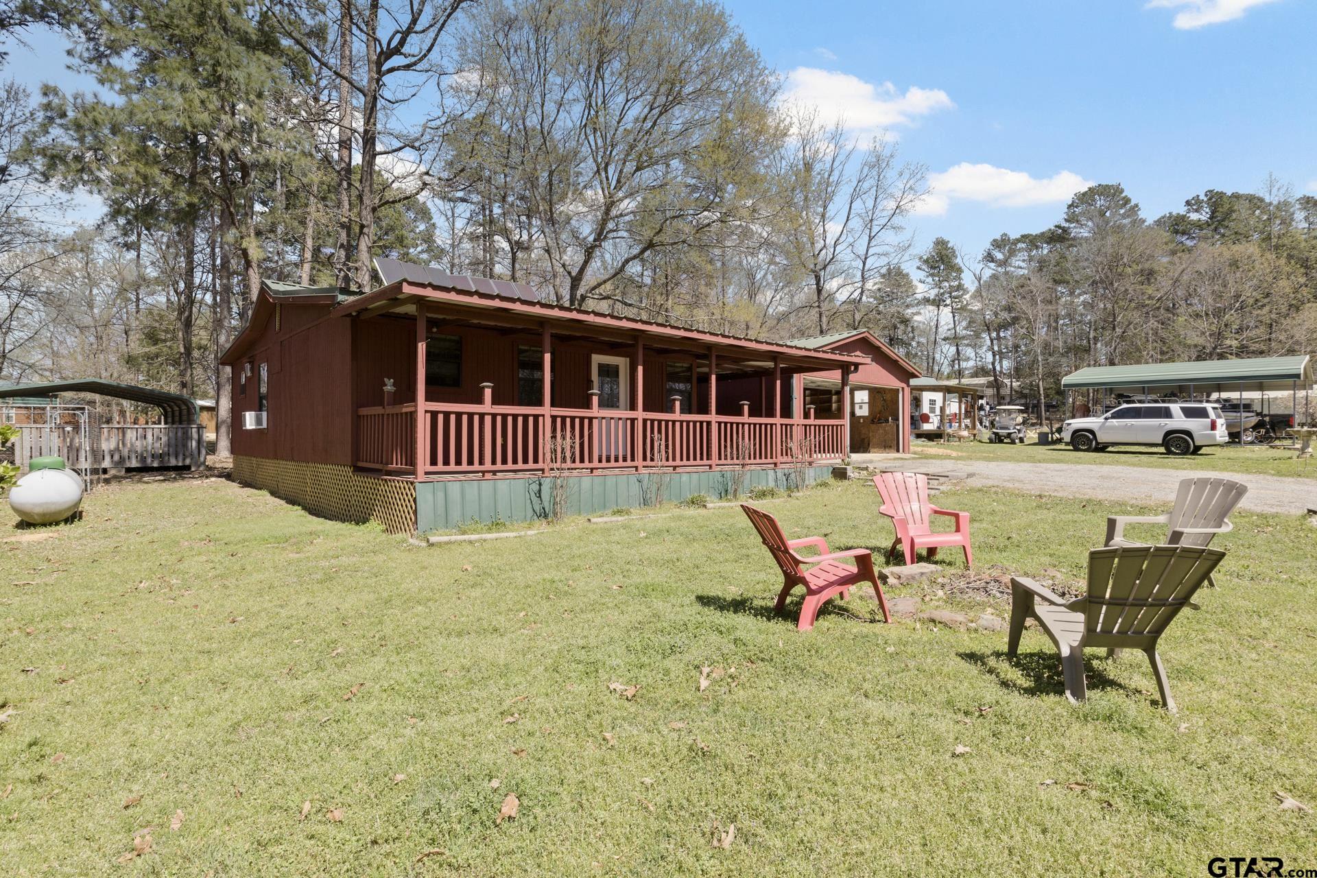71 Private Road Pittsburg, TX 75686 - Photo 23 of 39 a backyard of a house with table and chairs