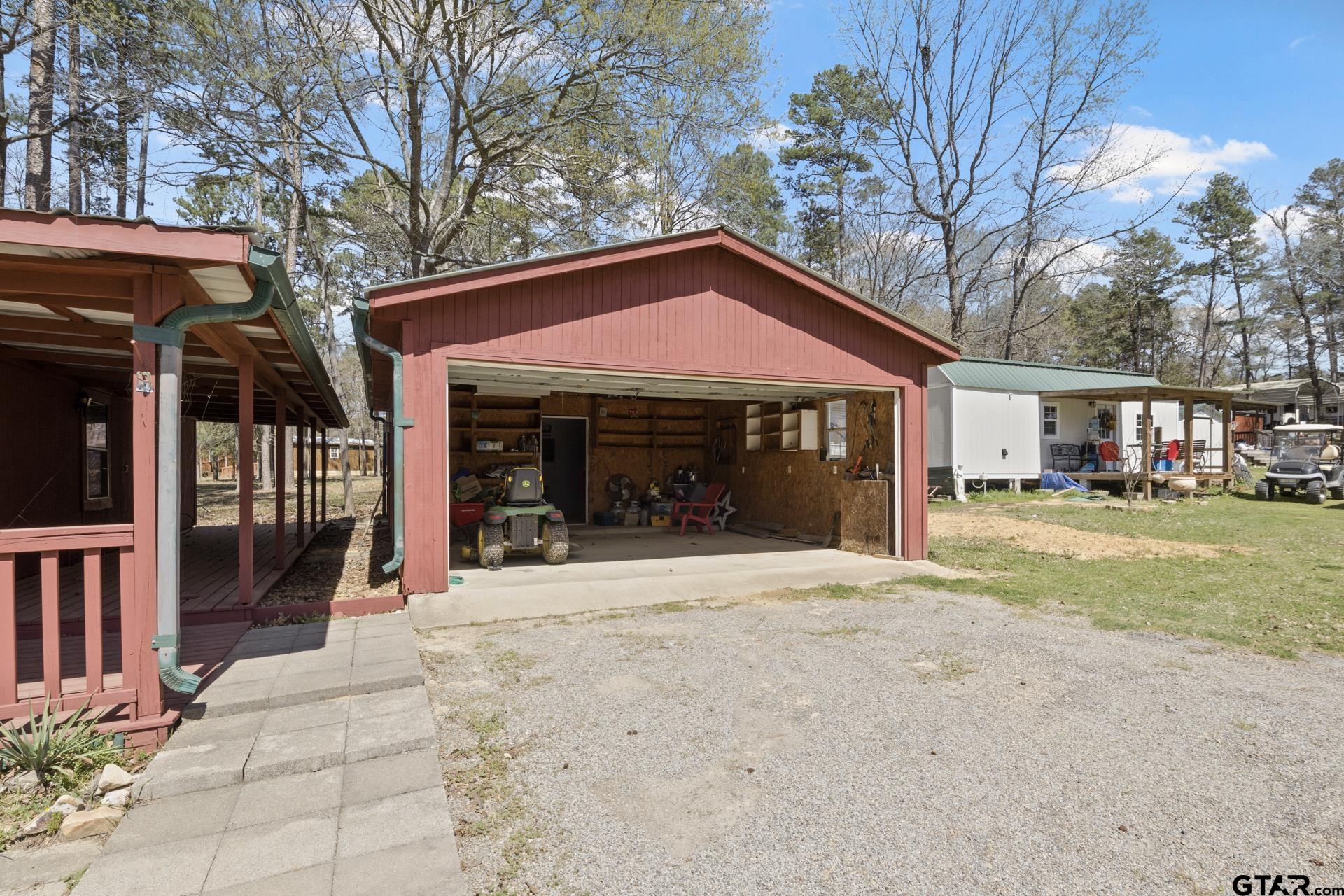 71 Private Road Pittsburg, TX 75686 - Photo 24 of 39 a front view of a house with a yard and potted plants