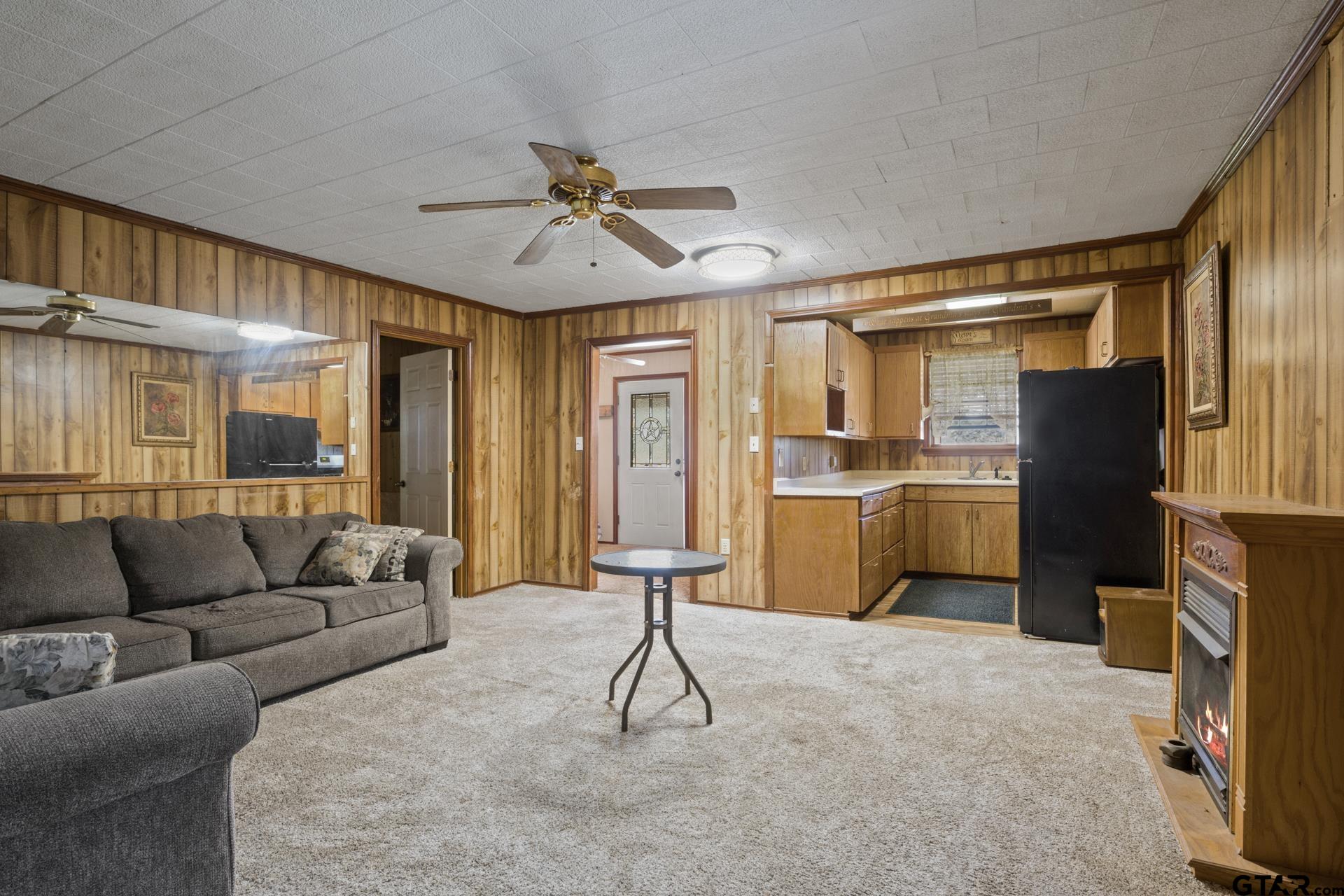 71 Private Road Pittsburg, TX 75686 - Photo 6 of 39 a living room with furniture a ceiling fan and a window