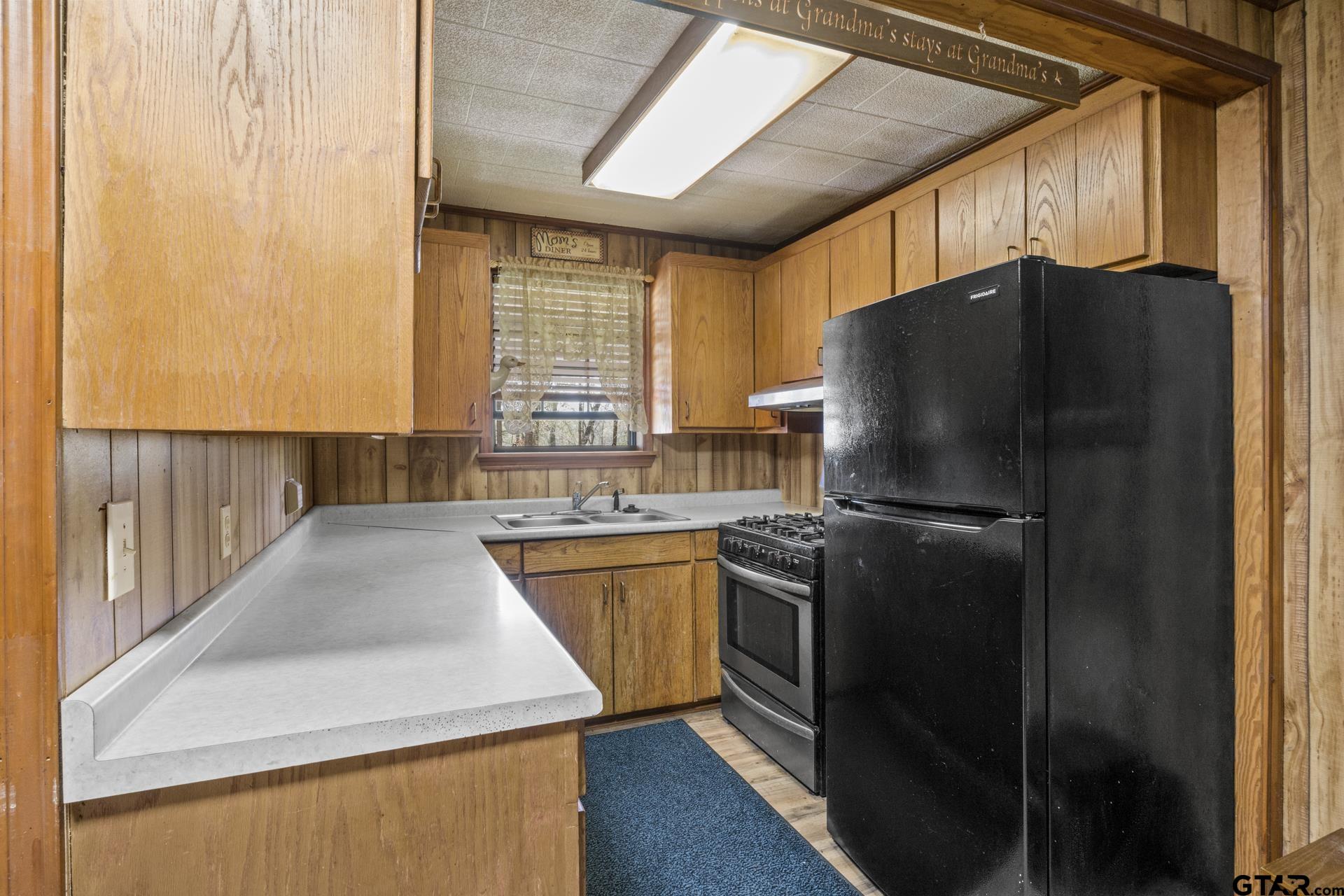 71 Private Road Pittsburg, TX 75686 - Photo 7 of 39 a kitchen with granite countertop a refrigerator and a sink