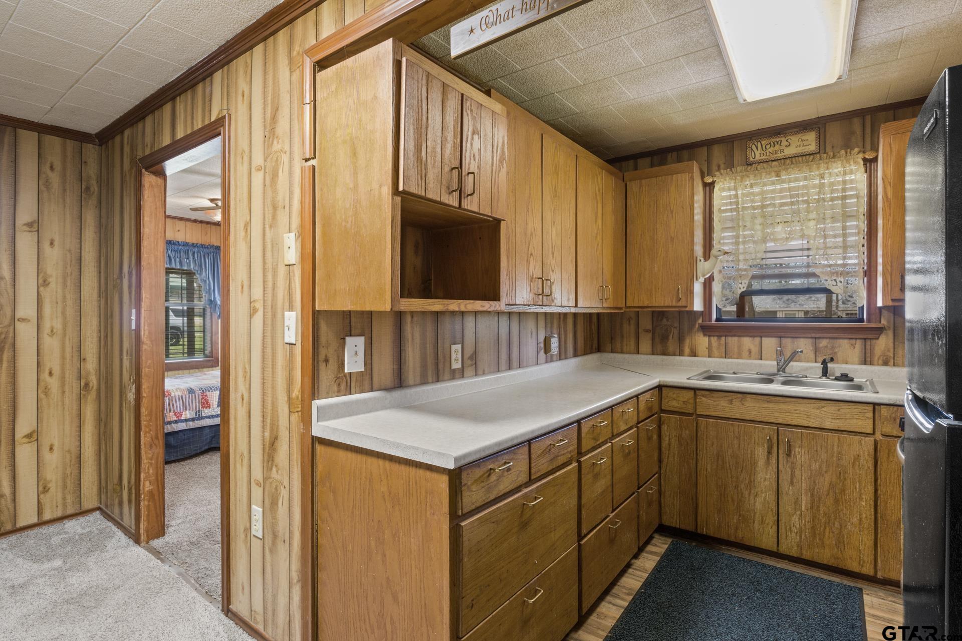 71 Private Road Pittsburg, TX 75686 - Photo 8 of 39 a kitchen with a sink and cabinets