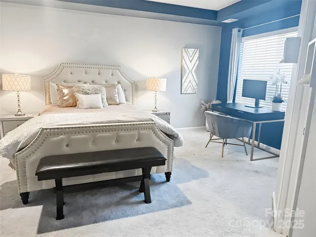 a bedroom with a bed a desk and chair