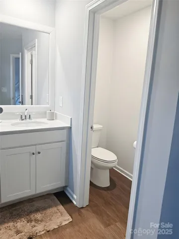 a spacious bathroom with a toilet sink and a mirror
