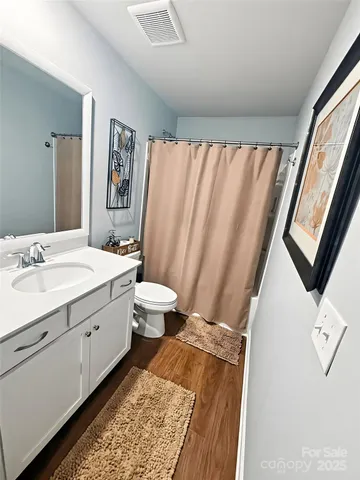 a spacious bathroom with a double vanity sink and a mirror