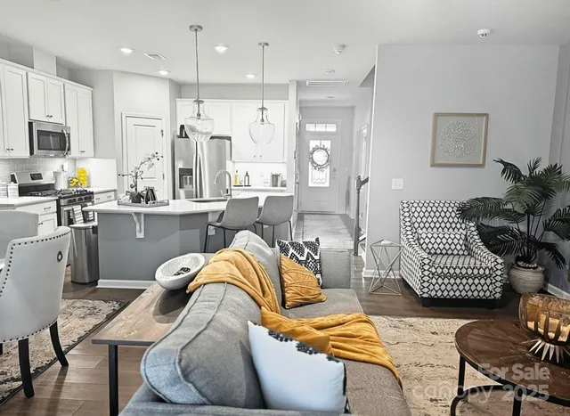 a kitchen with stainless steel appliances kitchen island granite countertop a refrigerator and wooden cabinets