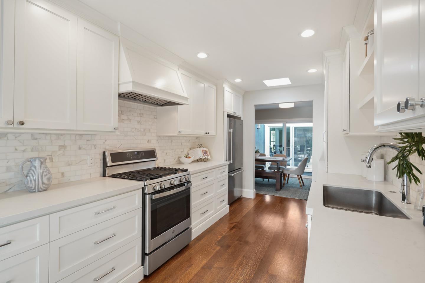 208 Bentley Square Mountain View, CA 94040 - Photo 4 of 17 a kitchen with stainless steel appliances white cabinets and wooden floor