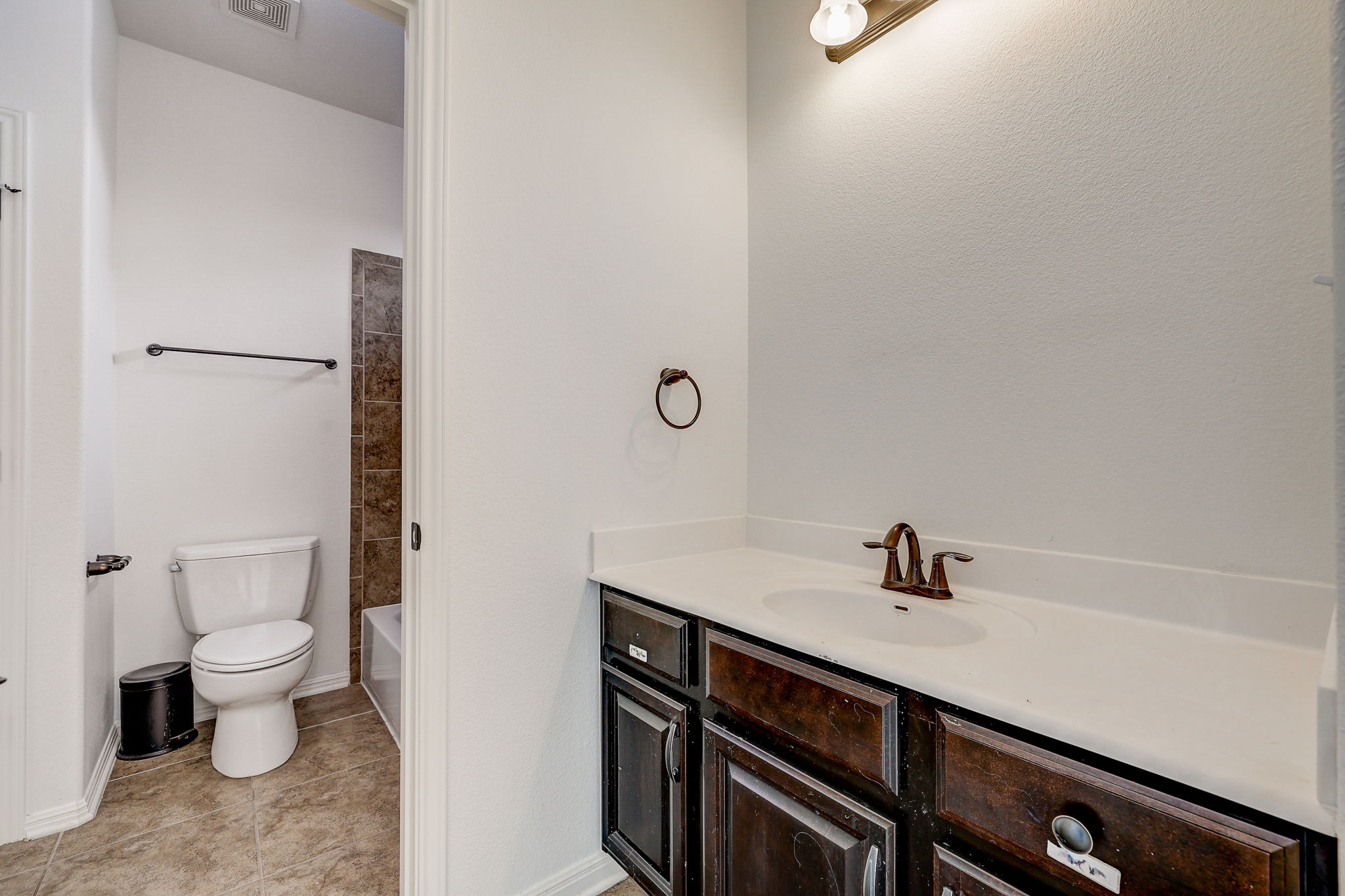 16012 Spillman Ranch Loop Austin, TX 78738 - Photo 25 of 38 A classic white vanity provides essential storage in this well-appointed bathroom.
