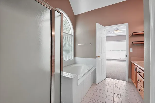 a bathroom with a tub and shower