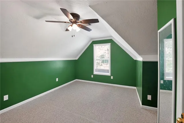 a view of a room that has a fan and window