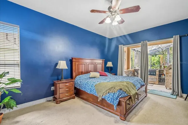 a bedroom with a bed a window and a chandelier