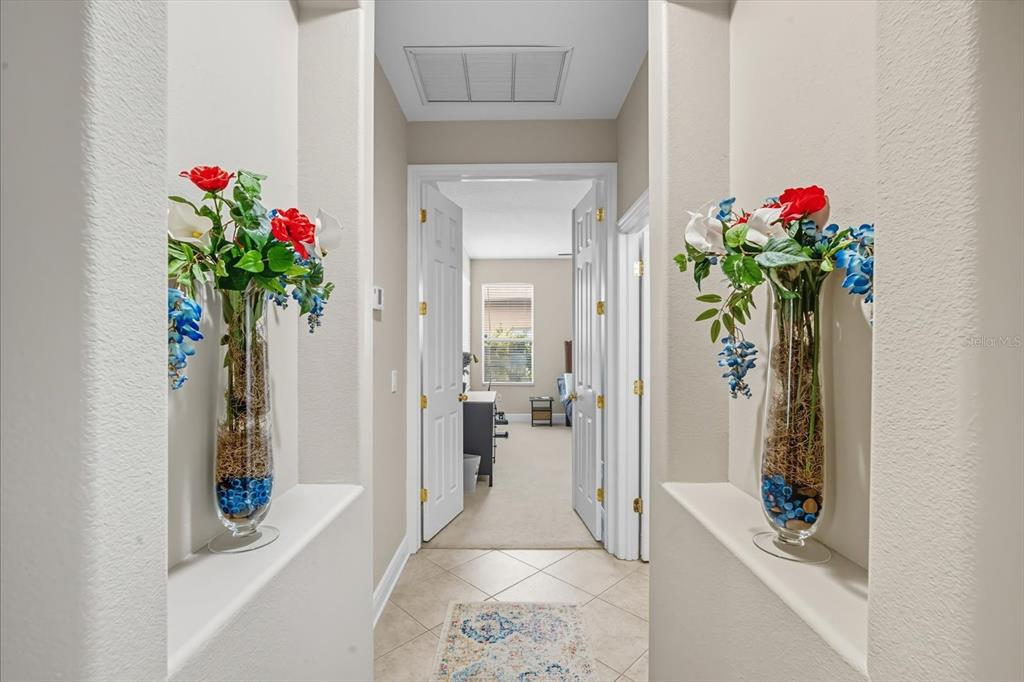 6107 Ibispark Drive Lithia, FL 33547 - Photo 19 of 42 a hallway with beautiful flowers