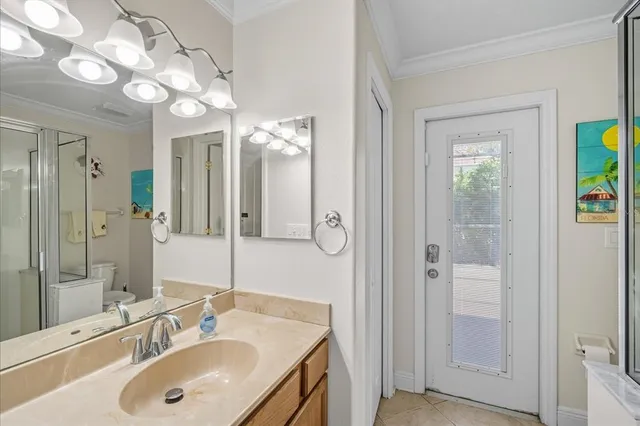 a bathroom with a sink vanity granite shower and a mirror