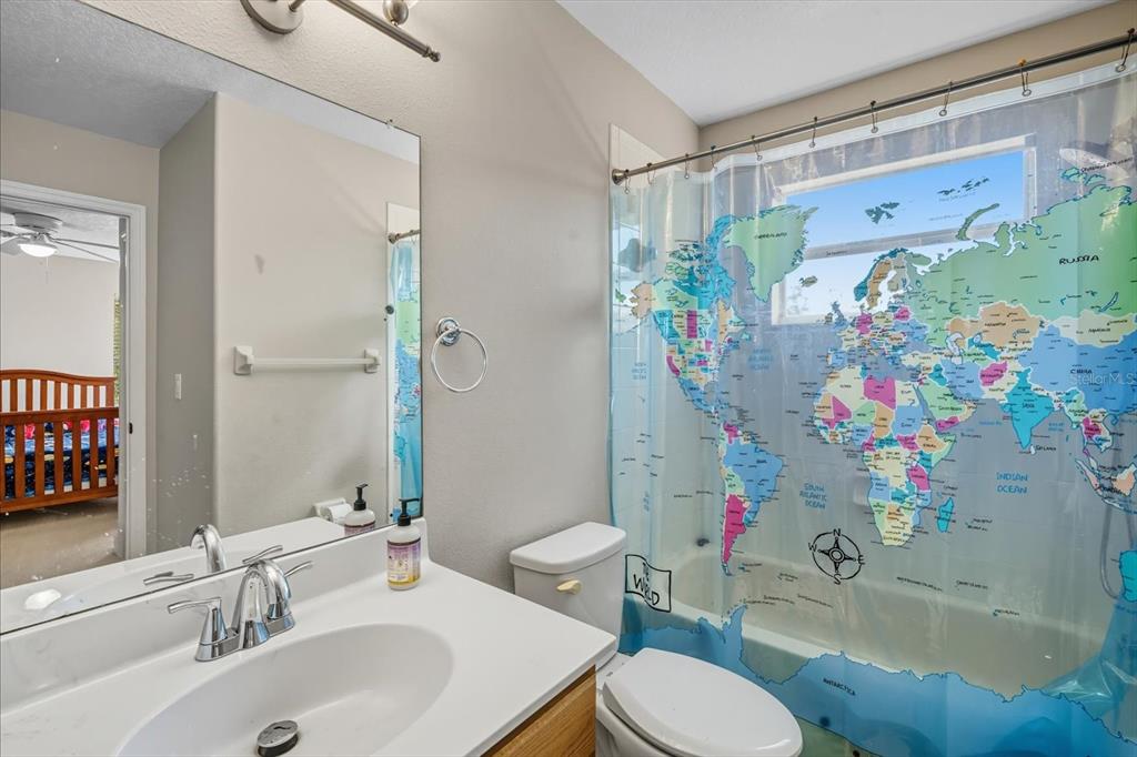 6107 Ibispark Drive Lithia, FL 33547 - Photo 26 of 42 a bathroom with a sink toilet and shower