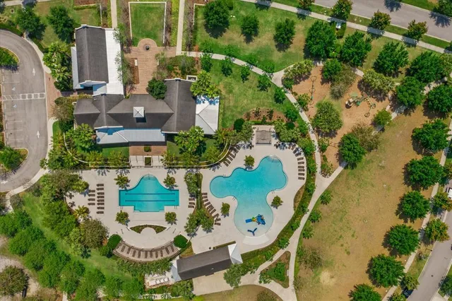 an aerial view of residential houses with outdoor space and parking