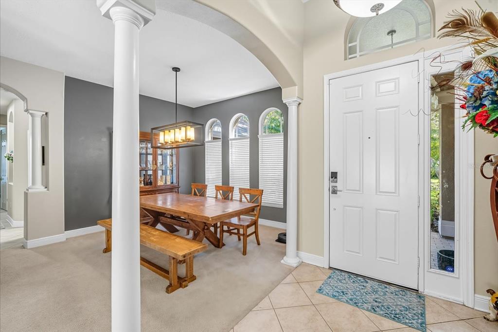 6107 Ibispark Drive Lithia, FL 33547 - Photo 6 of 42 a view of a dining room with furniture window and wooden floor