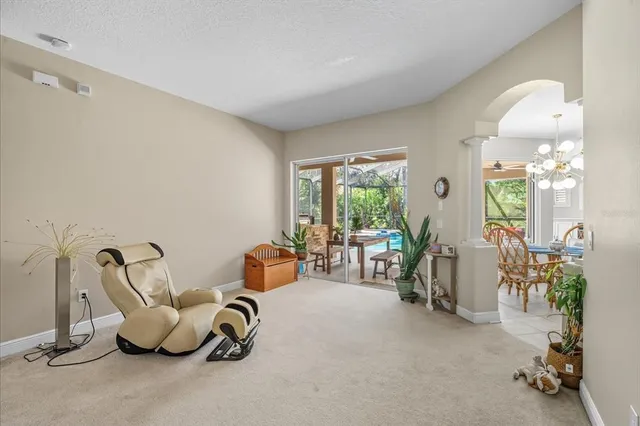 a room with gym equipment and large windows