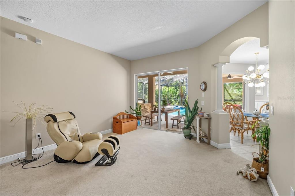 6107 Ibispark Drive Lithia, FL 33547 - Photo 8 of 42 a room with gym equipment and large windows